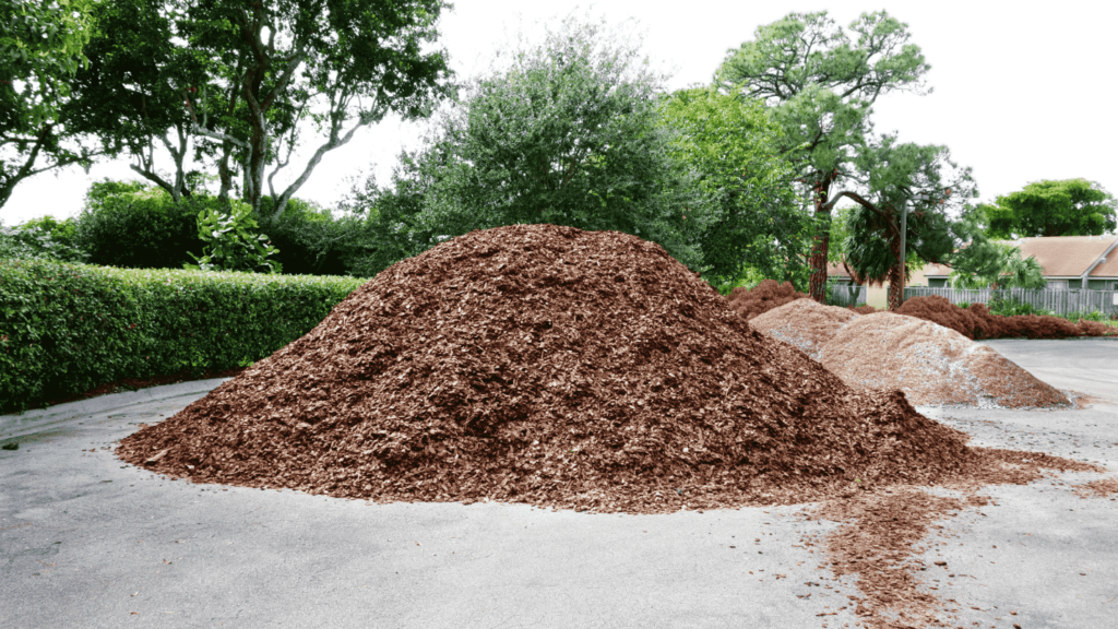 A pile of bark mulch in a drive way.