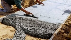 Contractors smooth out concrete to create a pathway